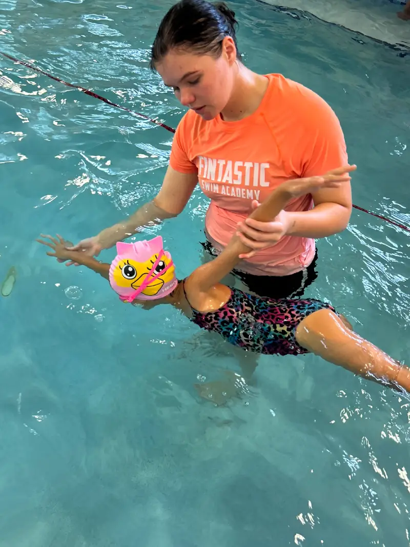 top view of a 7-year boy playing and swimming in the swimming pool