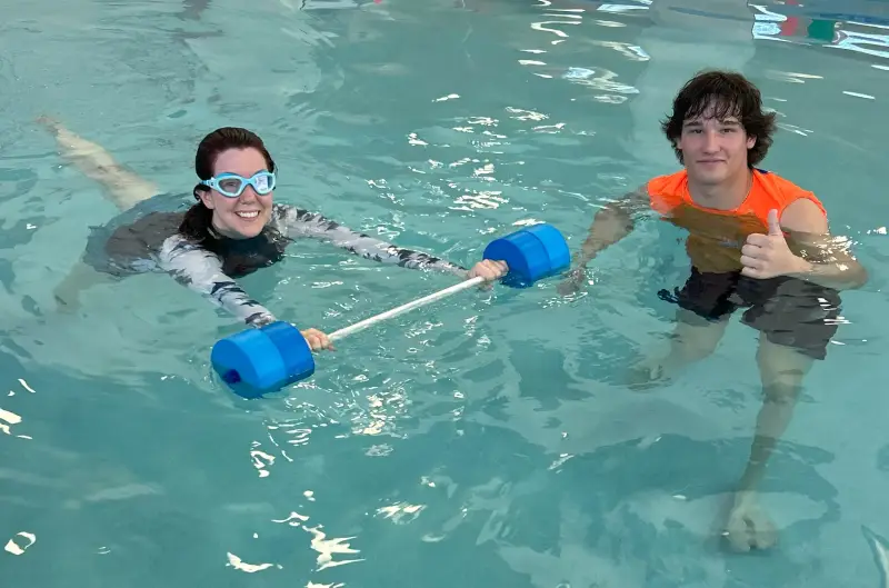 Child underwater. Funny face portrait of child boy swimming and diving underwater with fun in pool.